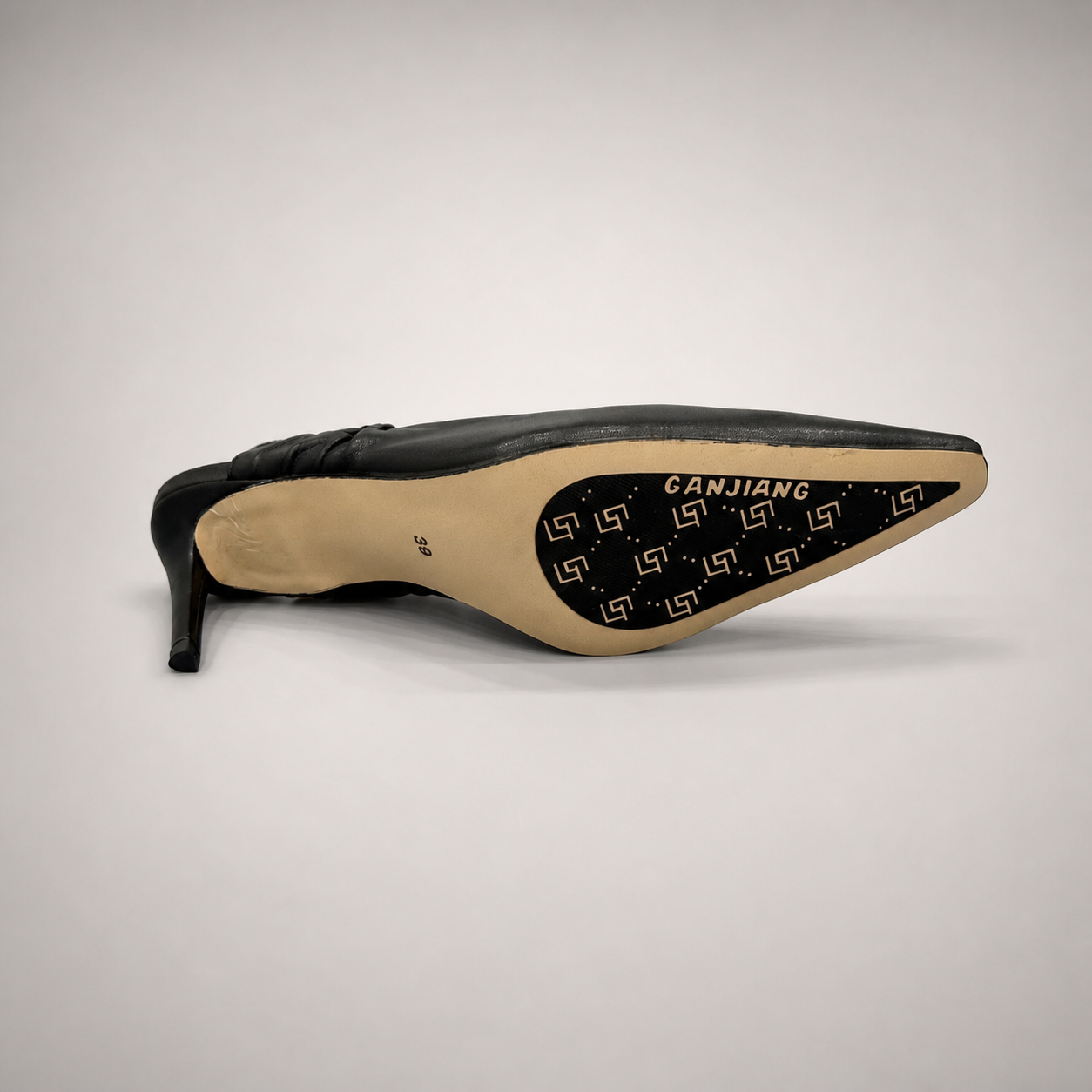 Black slingback pump outsole view showing the cow leather outsole