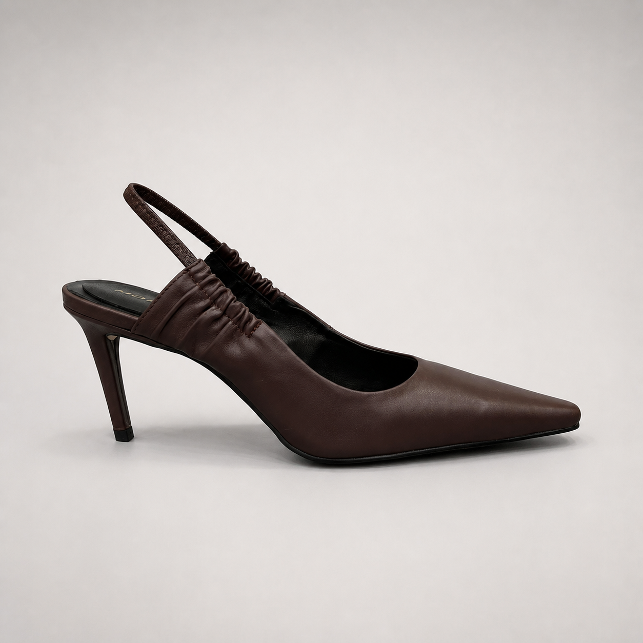 Brown slingback pump side profile showing a pointed toe and gathered slingback strap