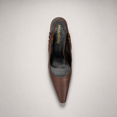 Brown slingback pump outsole view showing the cow leather outsole