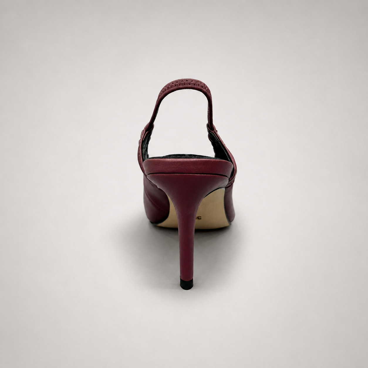Burgundy slingback pump rear view showing a pointed toe and gathered slingback strap