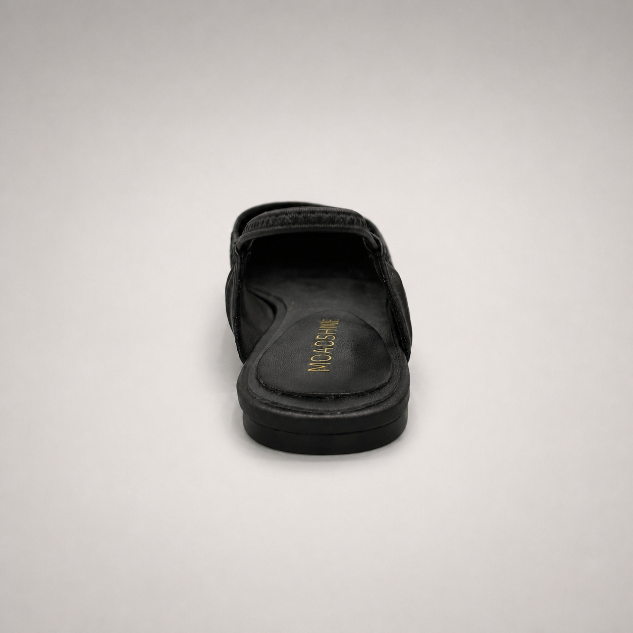 Black slingback flat rear view showing a square toe and gathered slingback strap