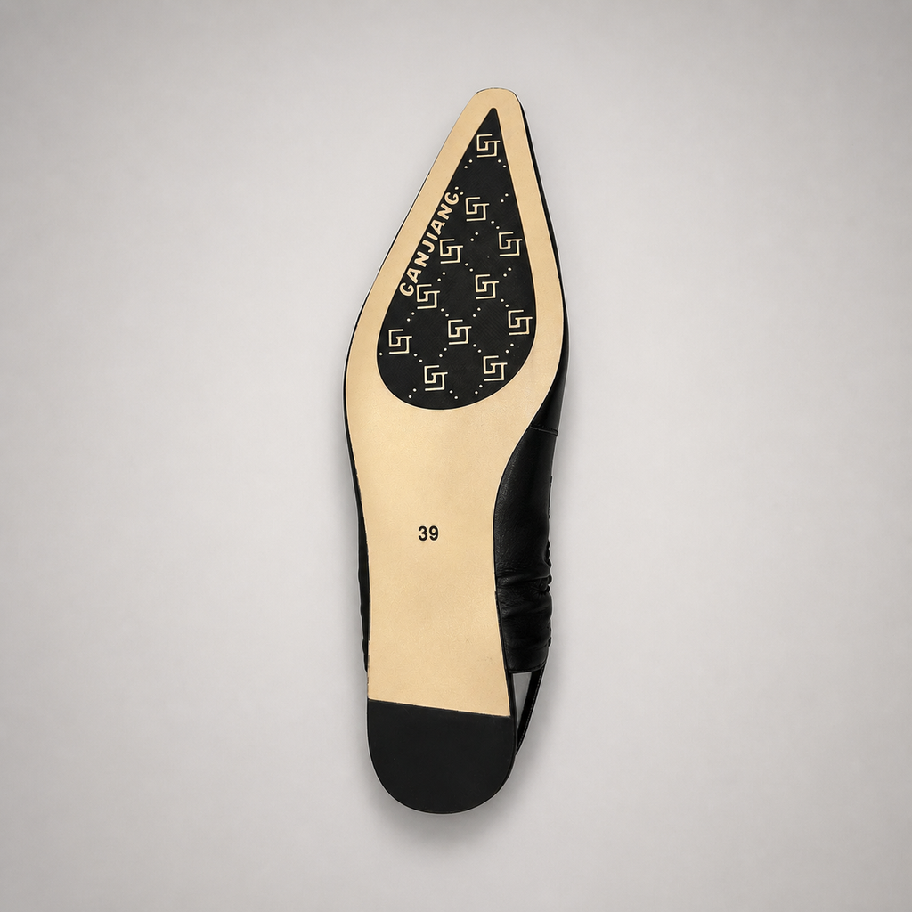 Black slingback flat top view showing a square toe and gathered slingback strap