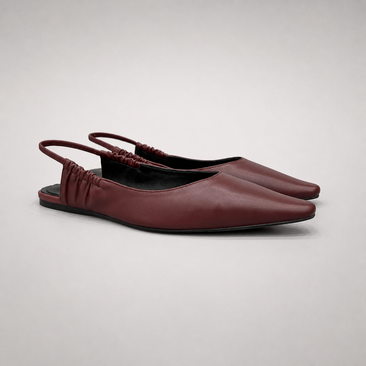 Burgundy slingback flat pair three-quarter view showing a square toe and gathered slingback strap