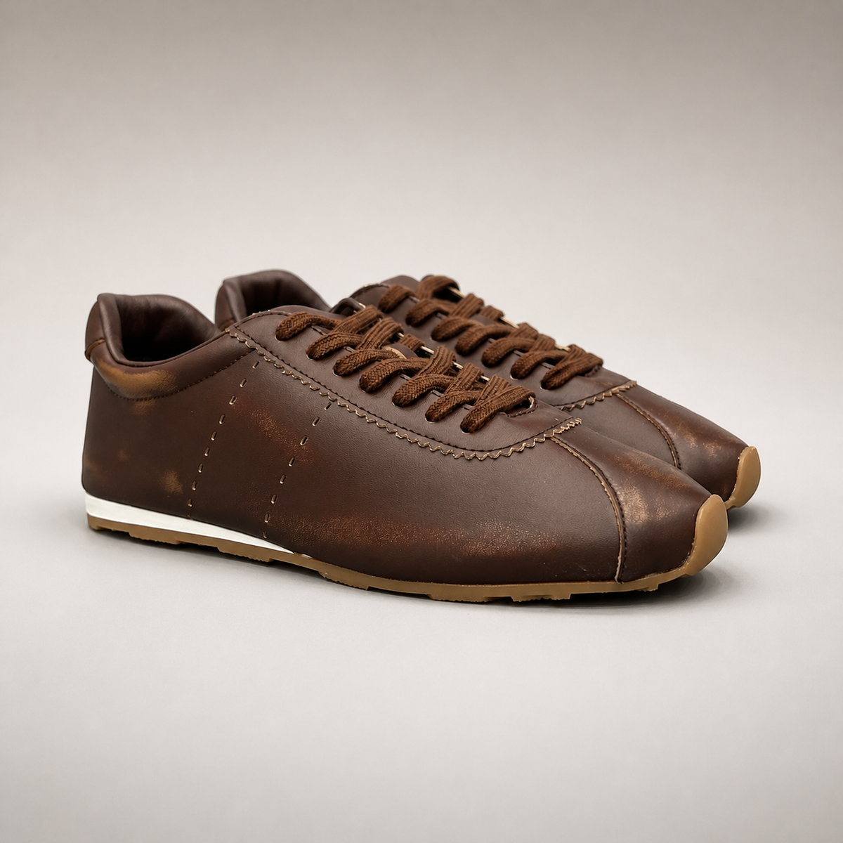 Brown low-profile lace-up sneaker pair three-quarter view