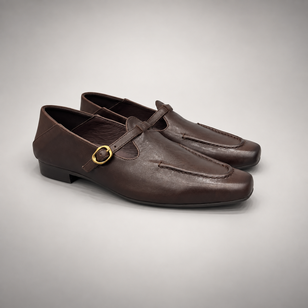 Dark brown leather buckle-strap shoe pair view