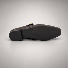 Dark brown leather buckle-strap shoe outsole view