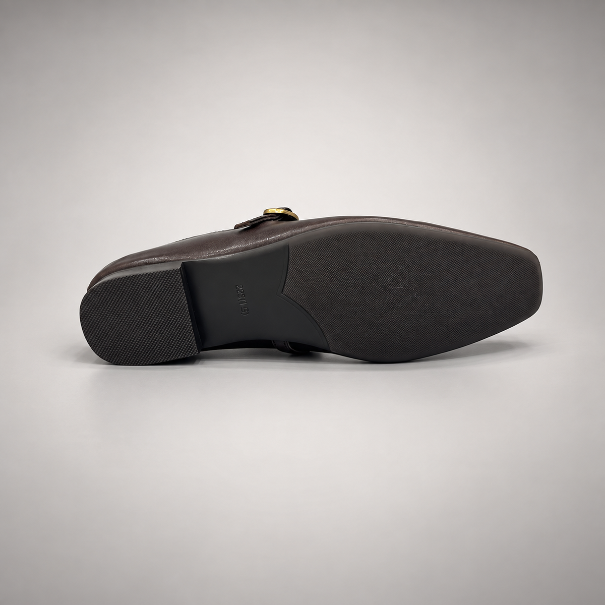 Dark brown leather buckle-strap shoe outsole view