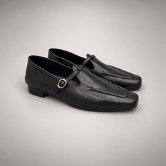 Black leather buckle-strap shoe pair view