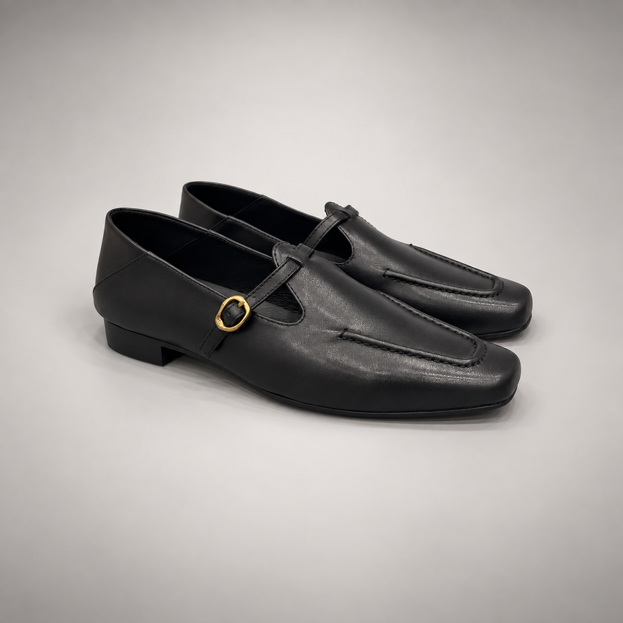 Black leather buckle-strap shoe pair view