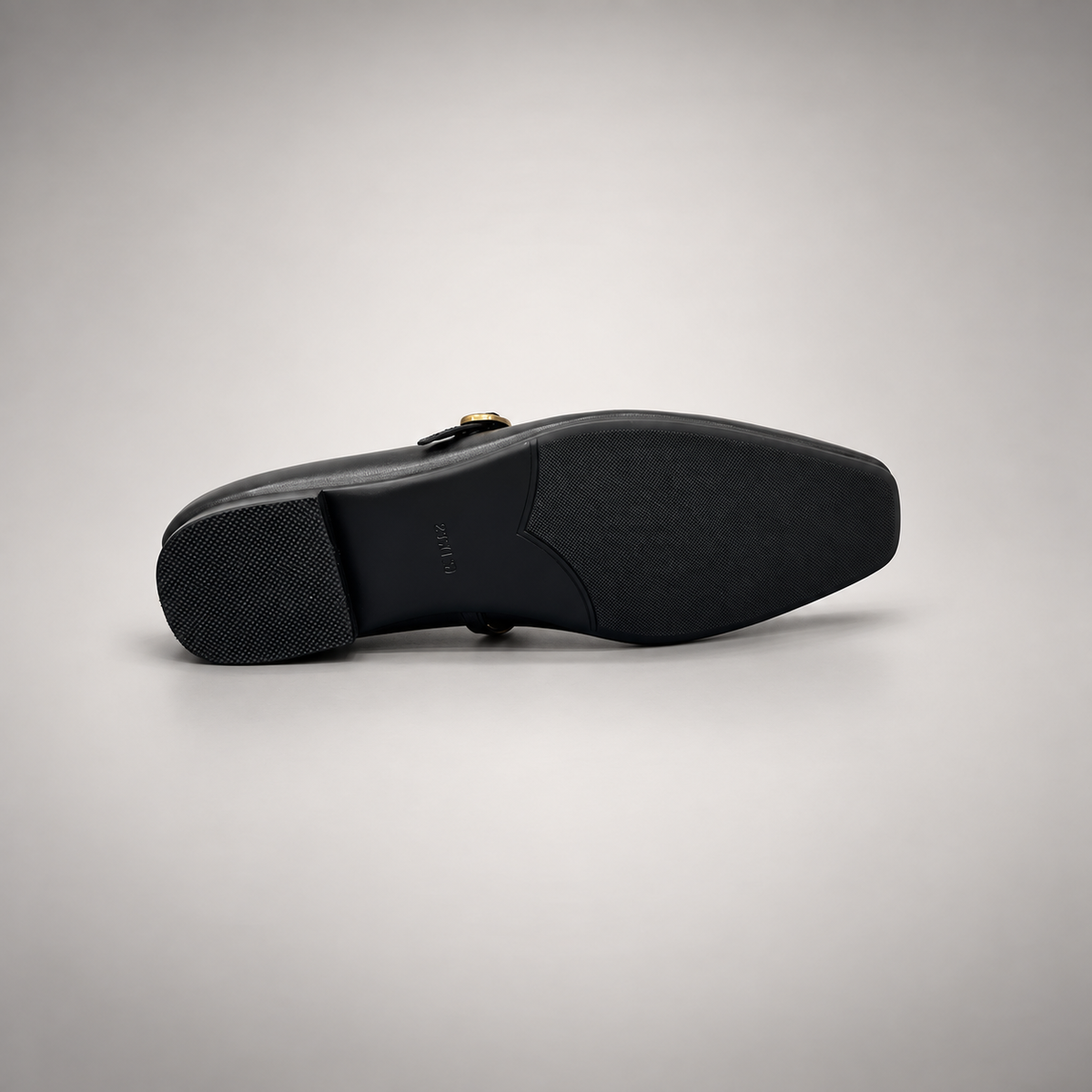 Black leather buckle-strap shoe outsole view