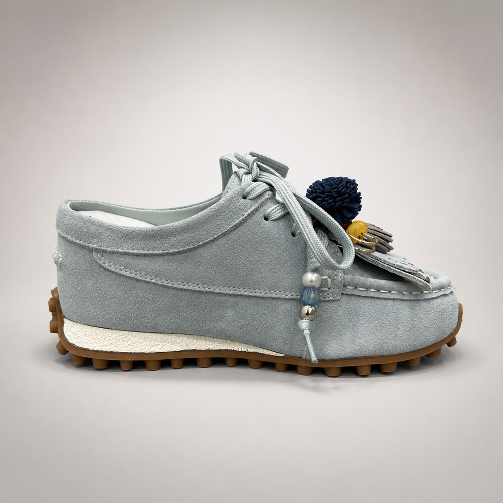 Light Blue moccasin sneaker opposite side profile showing fringe and tassel details over the laces