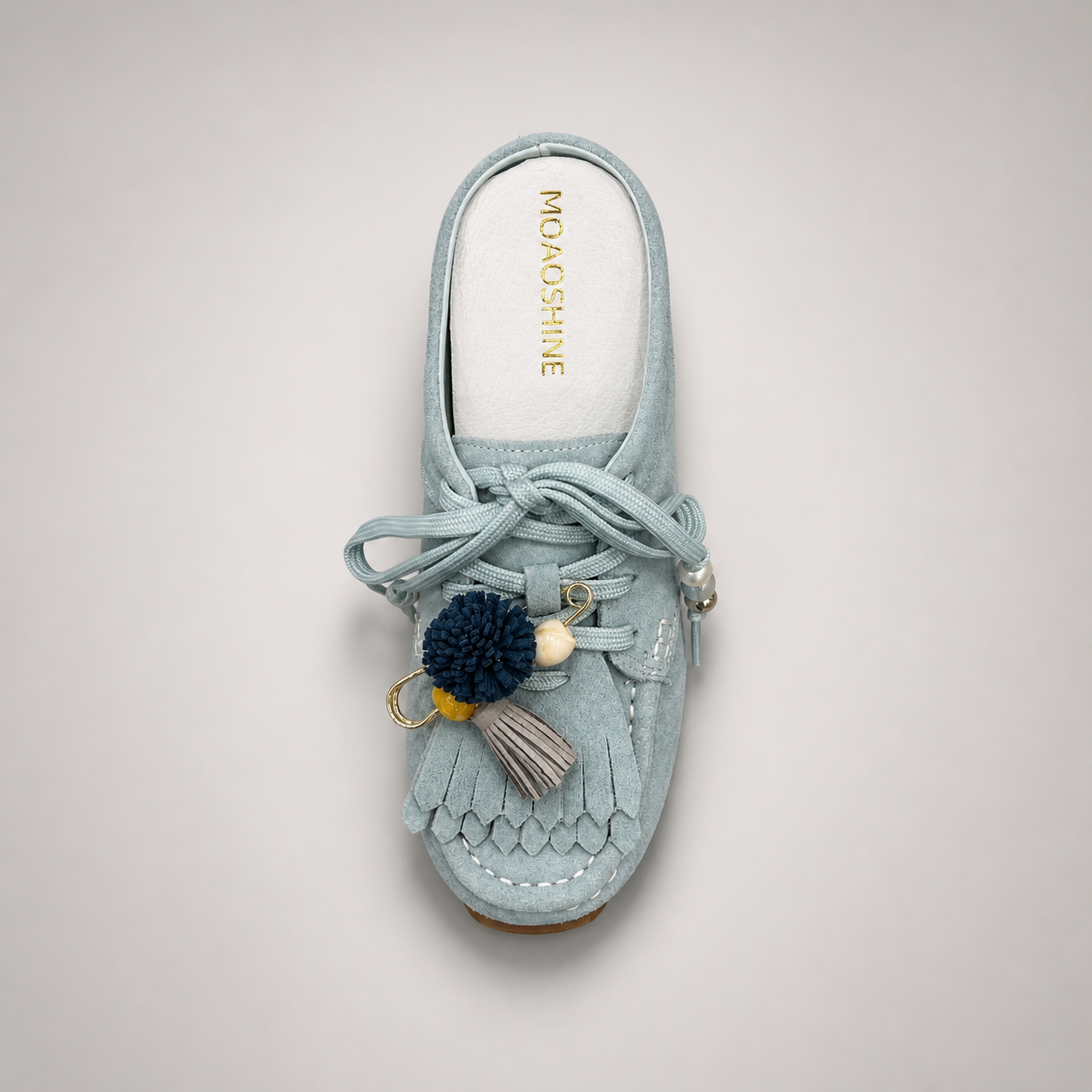 Light Blue moccasin sneaker top view showing fringe and tassel details over the laces