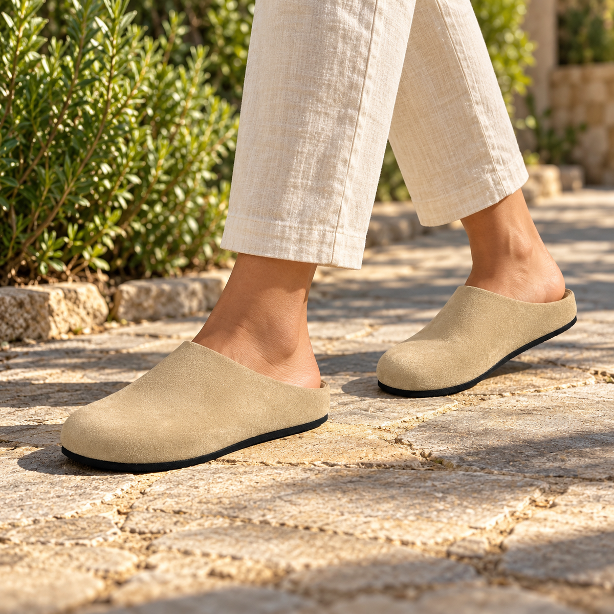 Beige calf suede slip-on mules worn outdoors