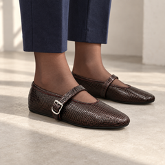 Burgundy snake-embossed oil-waxed leather buckle-strap flats worn with navy trousers and sheer hosiery