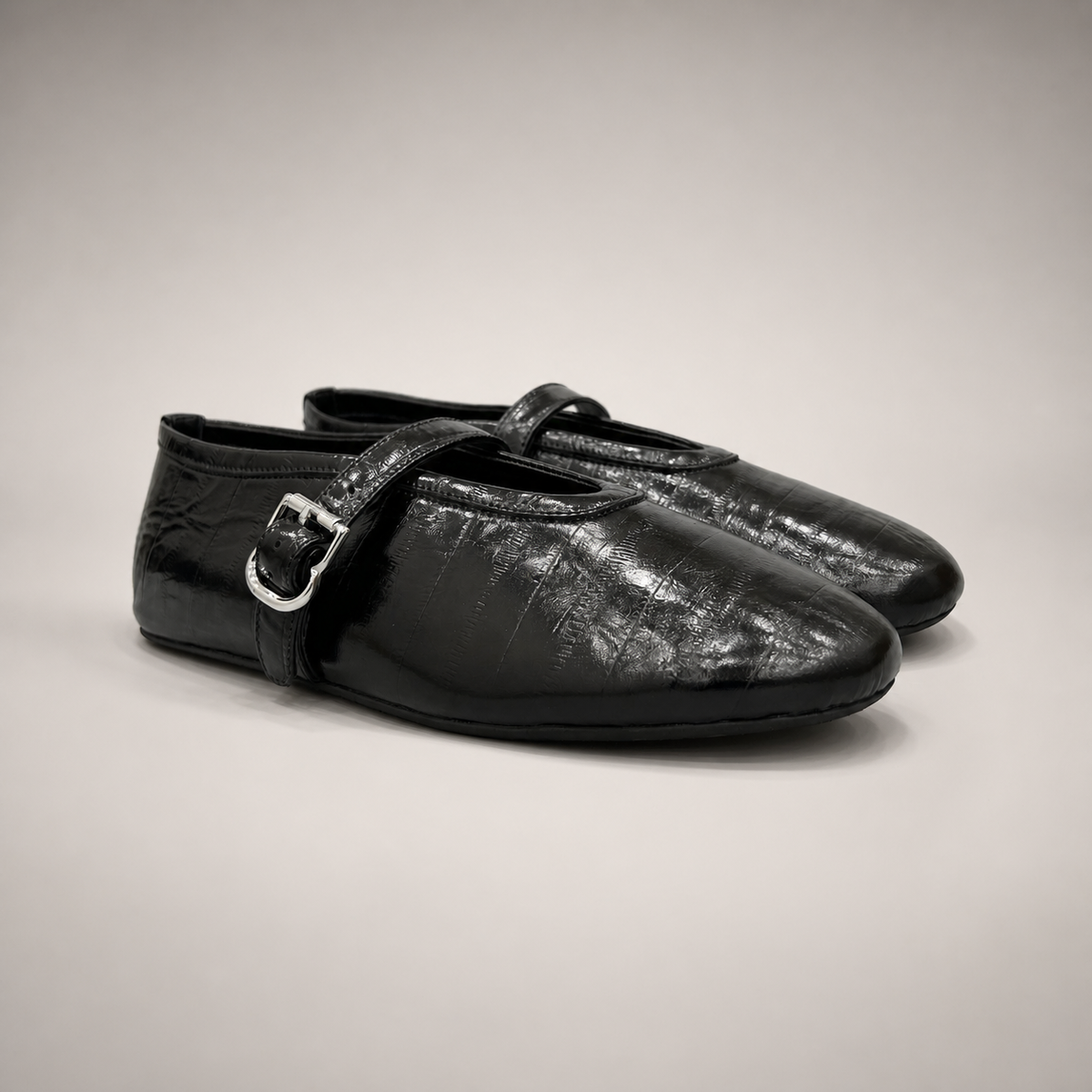 Black eel-embossed buckle-strap flat pair three-quarter view