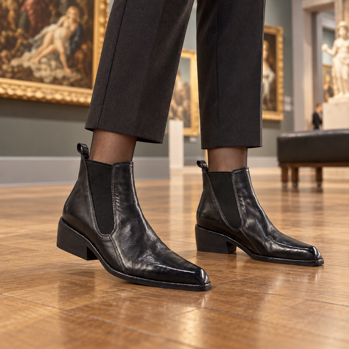 Black ankle boots worn on feet