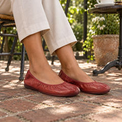 Red ballet flats worn on feet