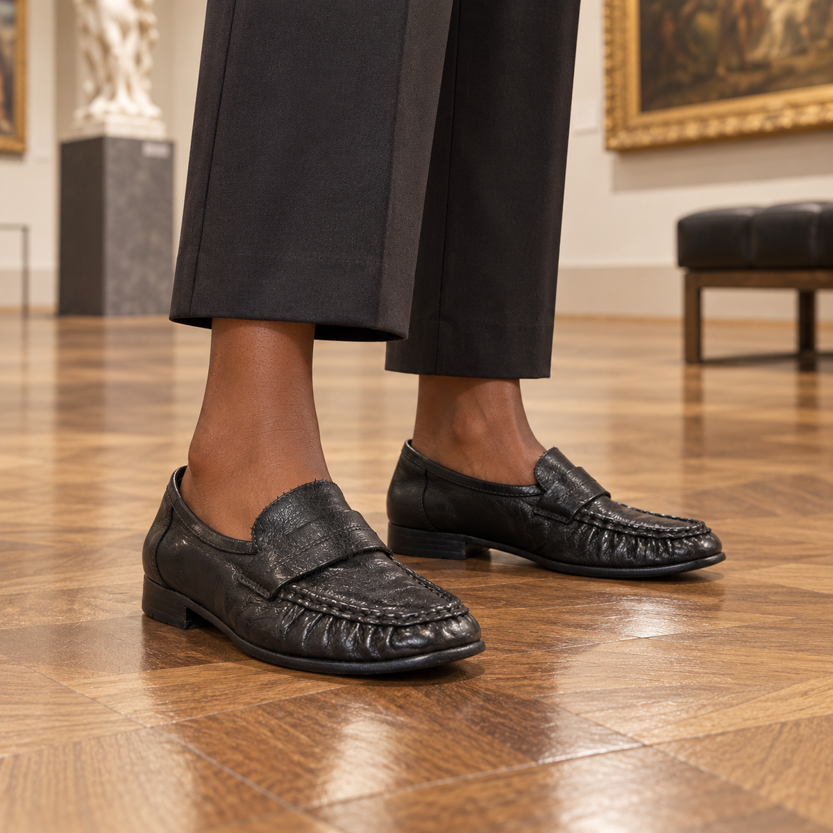 Black loafers worn on feet
