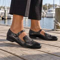 Black shoes worn on feet