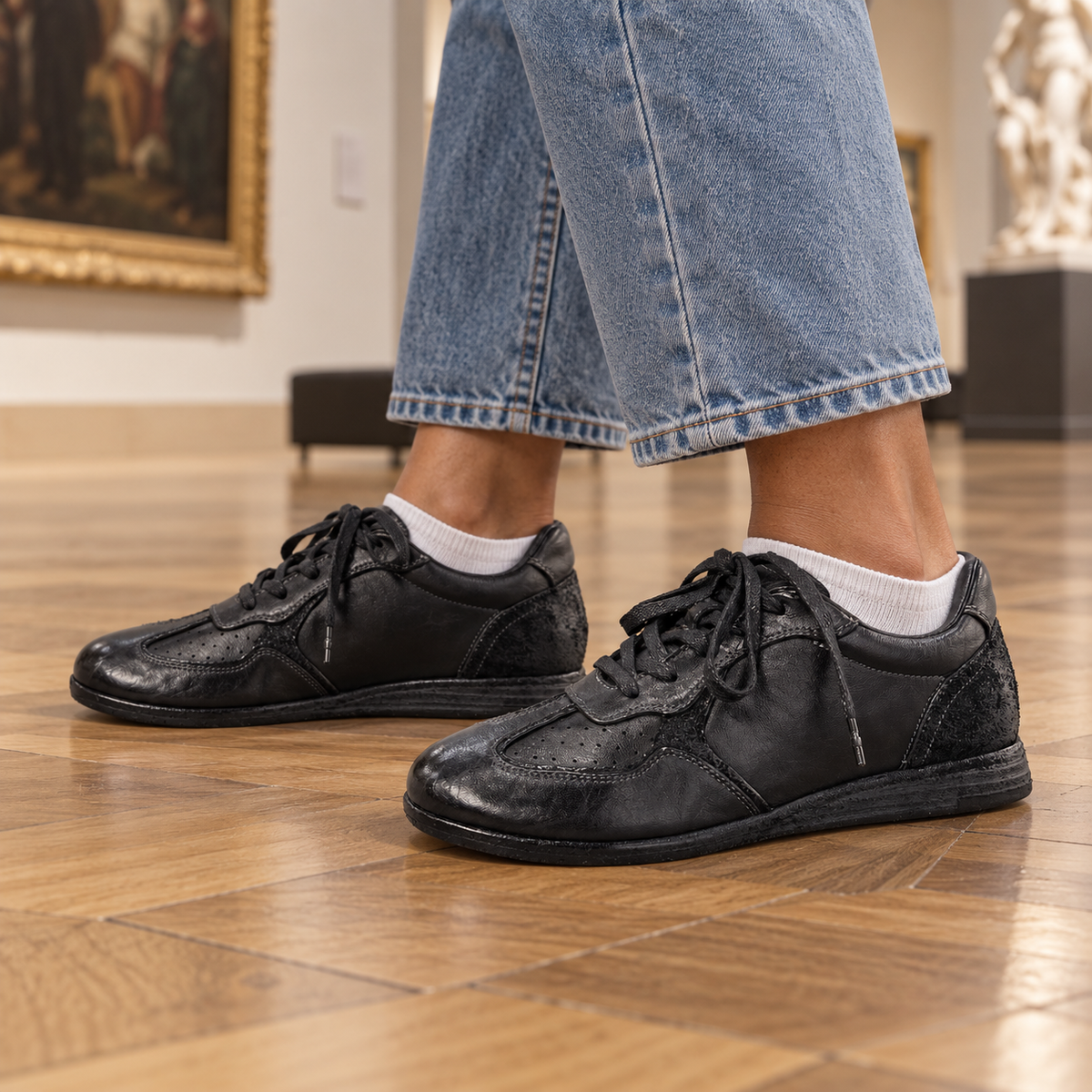 Black sneakers worn on feet
