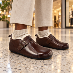Brown buckle flats worn on feet