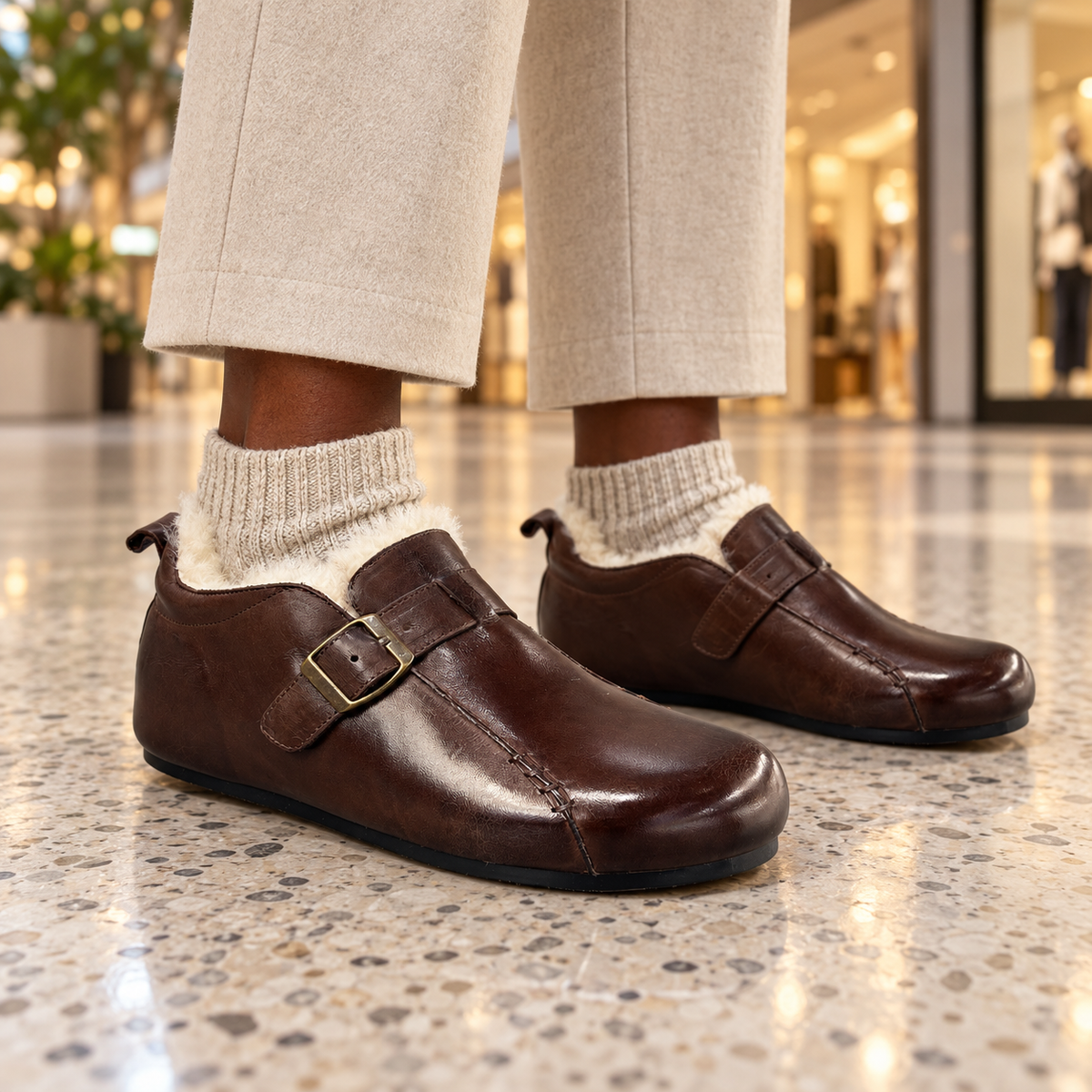 Brown buckle flats worn on feet