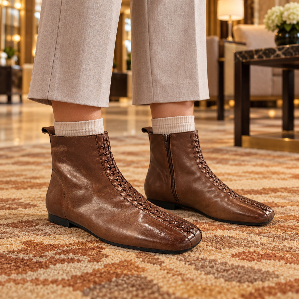 Brown ankle boots worn on feet