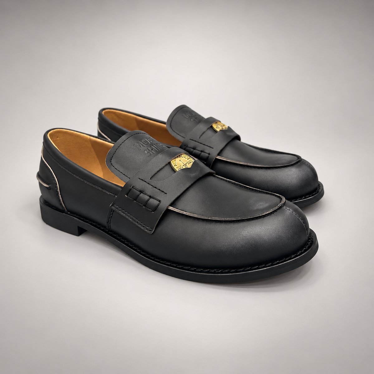 Black top-grain cow leather emblem loafers, pair