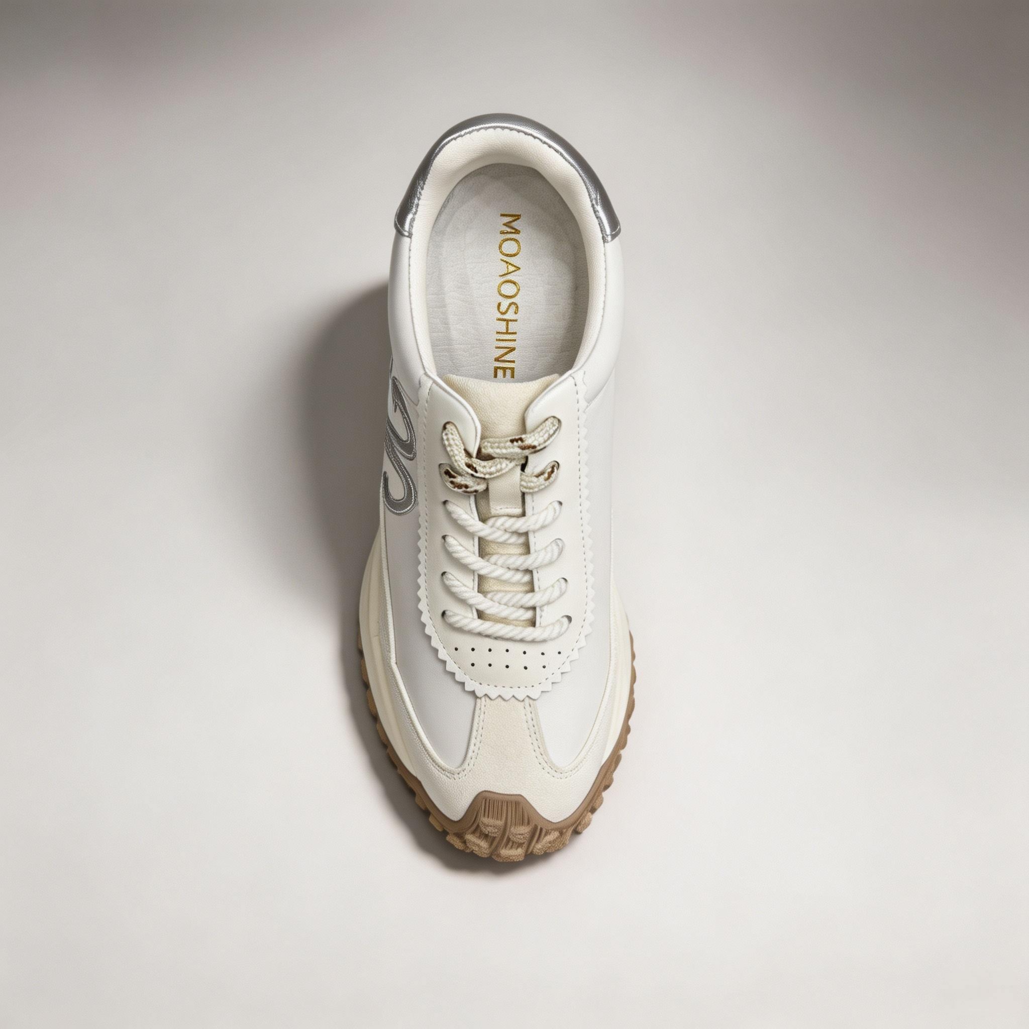 Silver sneaker top view showing a panelled lace-up upper