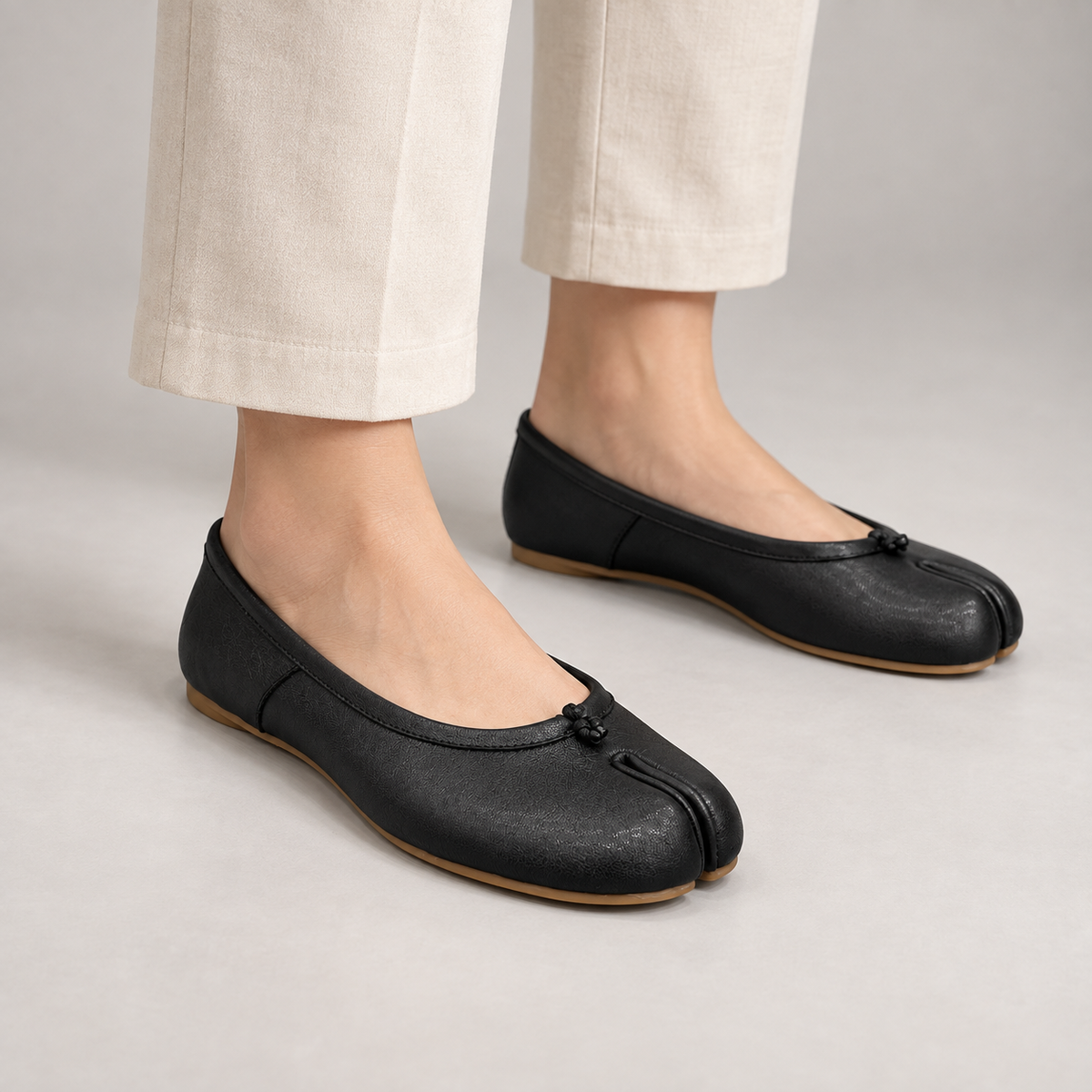 Black Leather Split-Toe Ballet Flats worn on foot