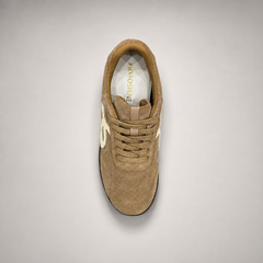 Tan soccer shoe top view showing a lace-up upper and molded outsole studs