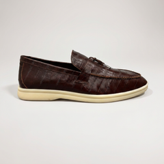 Brown loafer outer side profile showing an eel-pattern embossed vamp and tassel detail