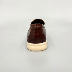 Brown loafer rear view showing an eel-pattern embossed vamp and tassel detail