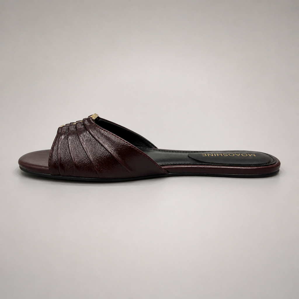 Brown slide sandal opposite side profile showing a pleated forefoot strap