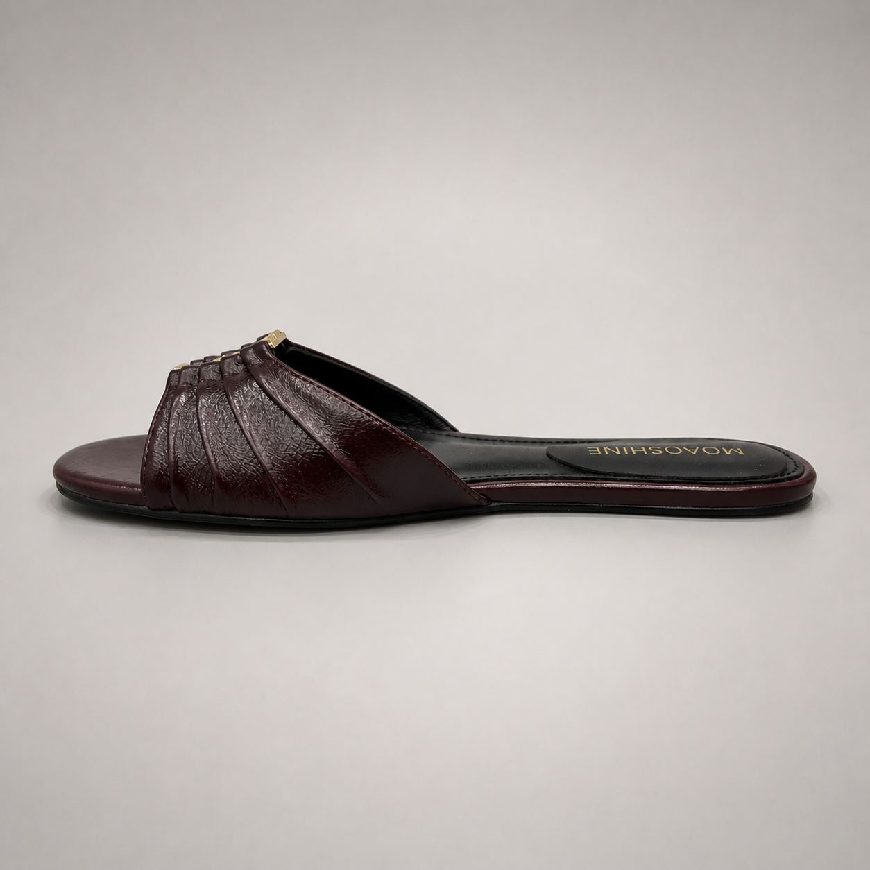 Brown slide sandal opposite side profile showing a pleated forefoot strap