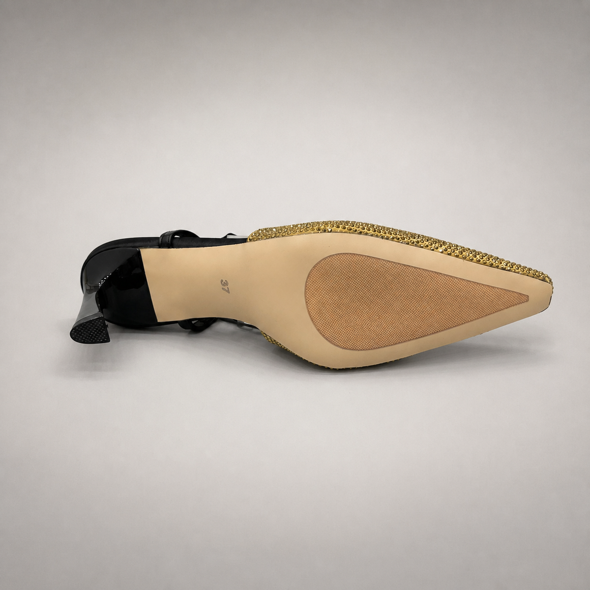 Gold slingback pump outsole view showing the cow leather outsole