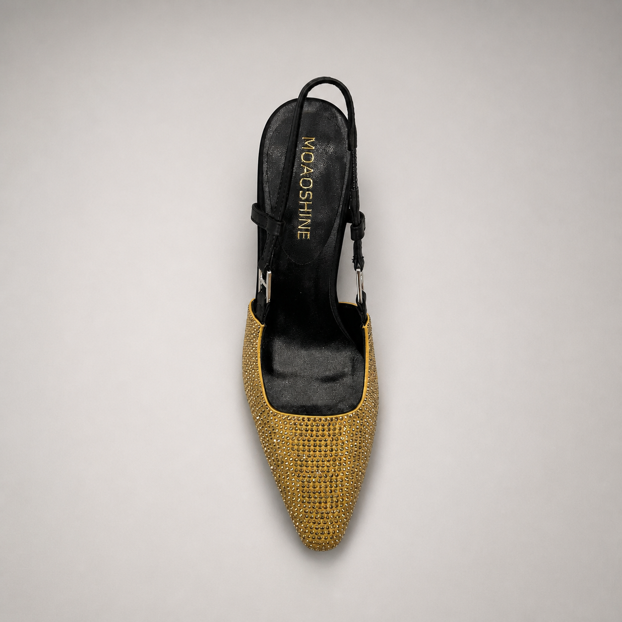 Gold slingback pump top view showing a pointed toe and double slingback straps