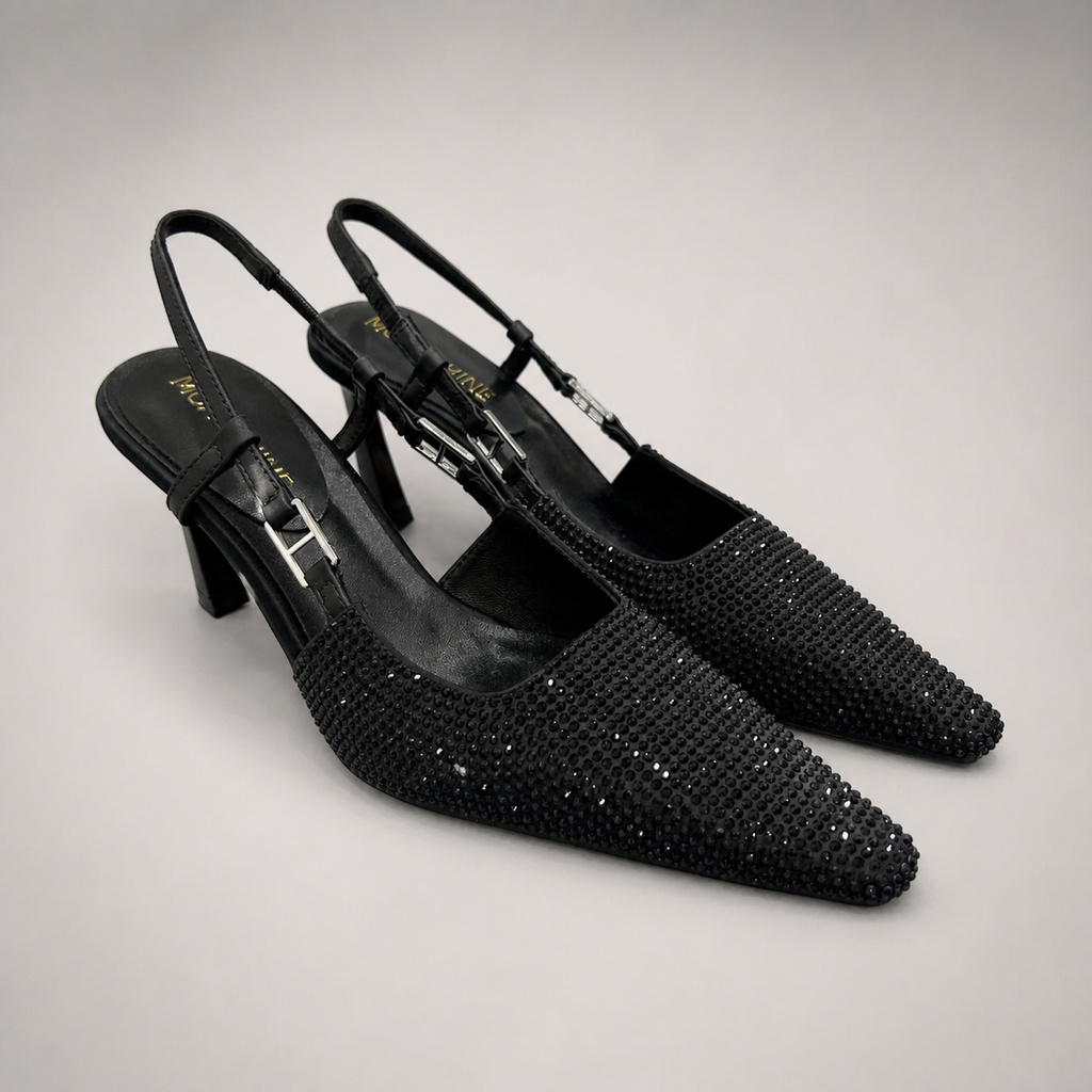 Black slingback pump pair three-quarter view showing a pointed toe and double slingback straps