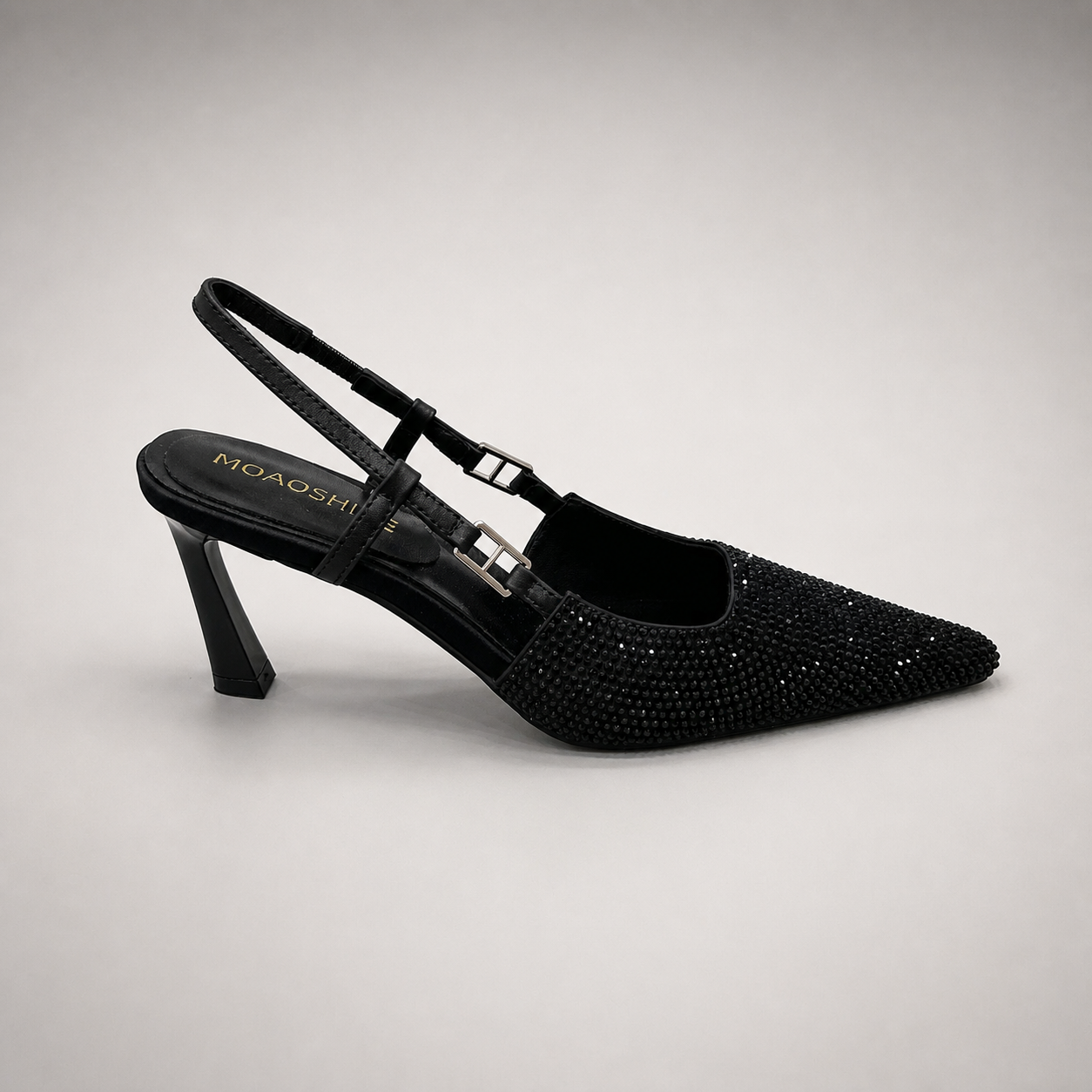 Black slingback pump side profile showing a pointed toe and double slingback straps