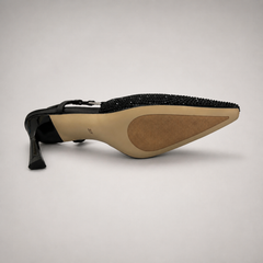 Black slingback pump outsole view showing the cow leather outsole