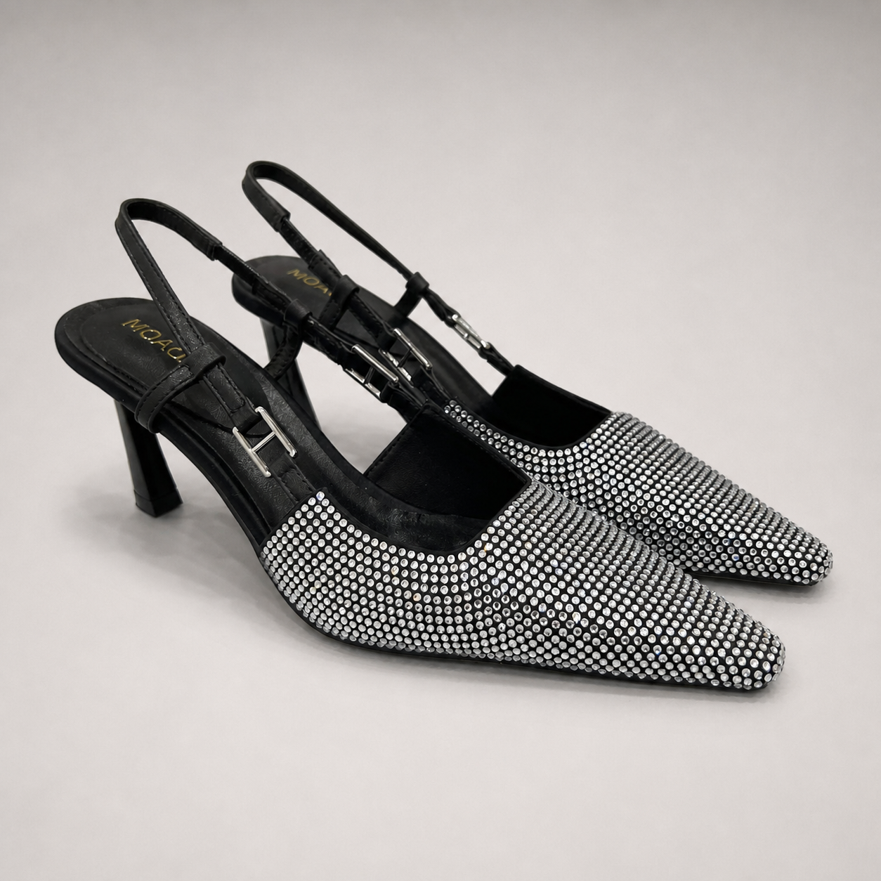 Gray slingback pump pair three-quarter view showing a pointed toe and double slingback straps