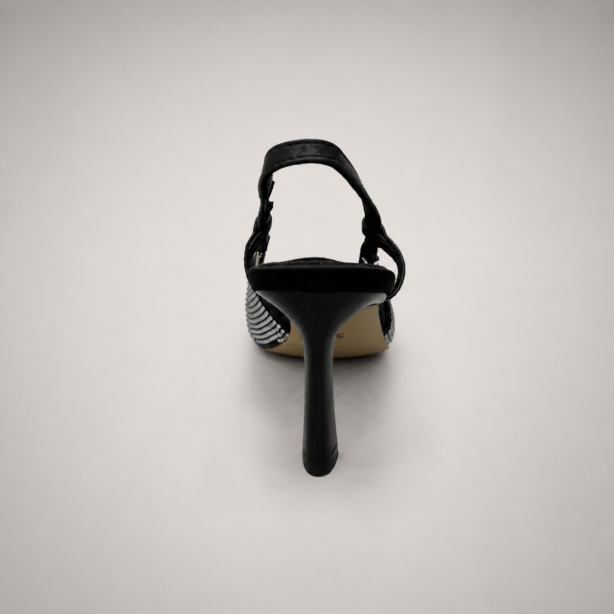 Gray slingback pump rear view showing a pointed toe and double slingback straps