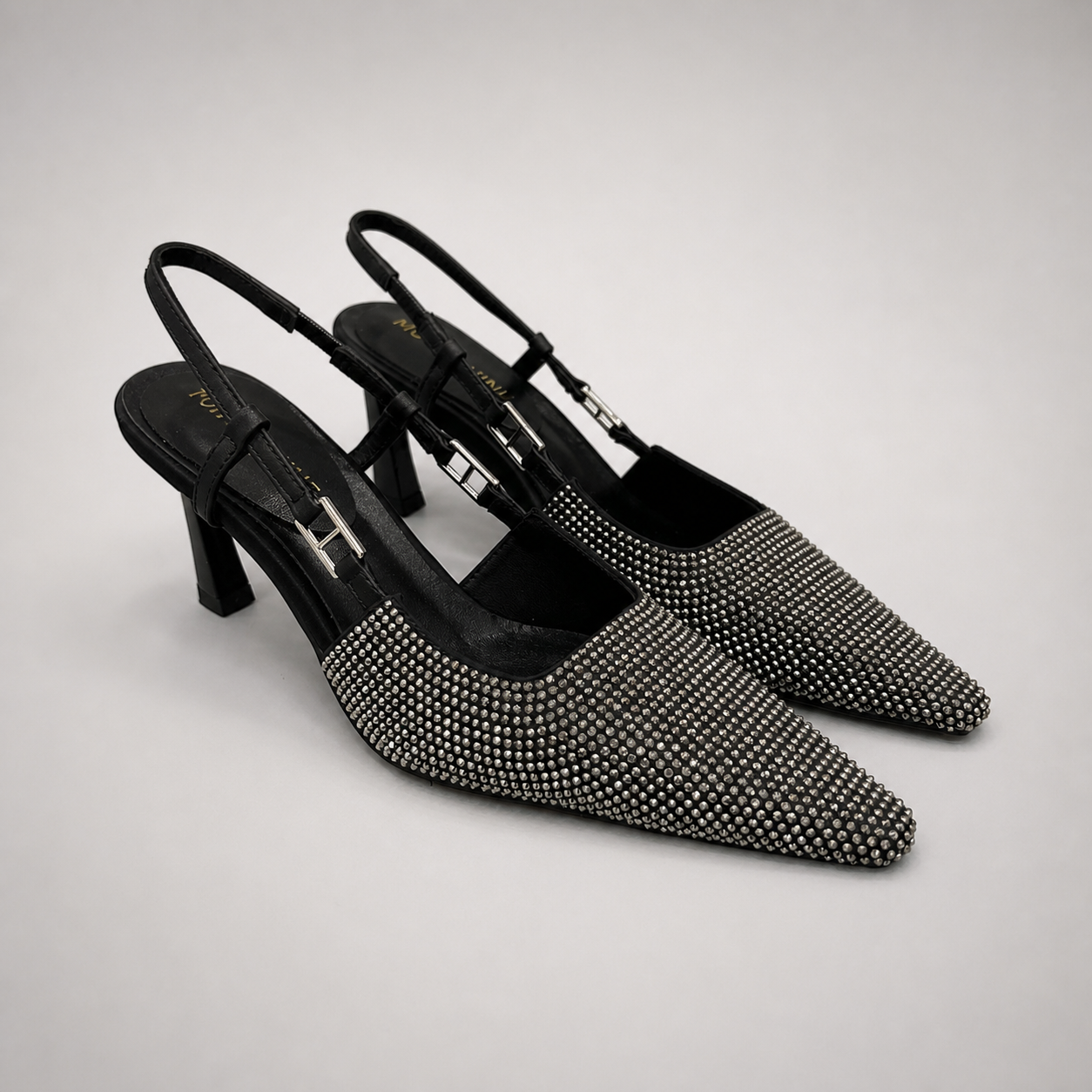 Gray slingback pump pair three-quarter view showing a pointed toe and double slingback straps