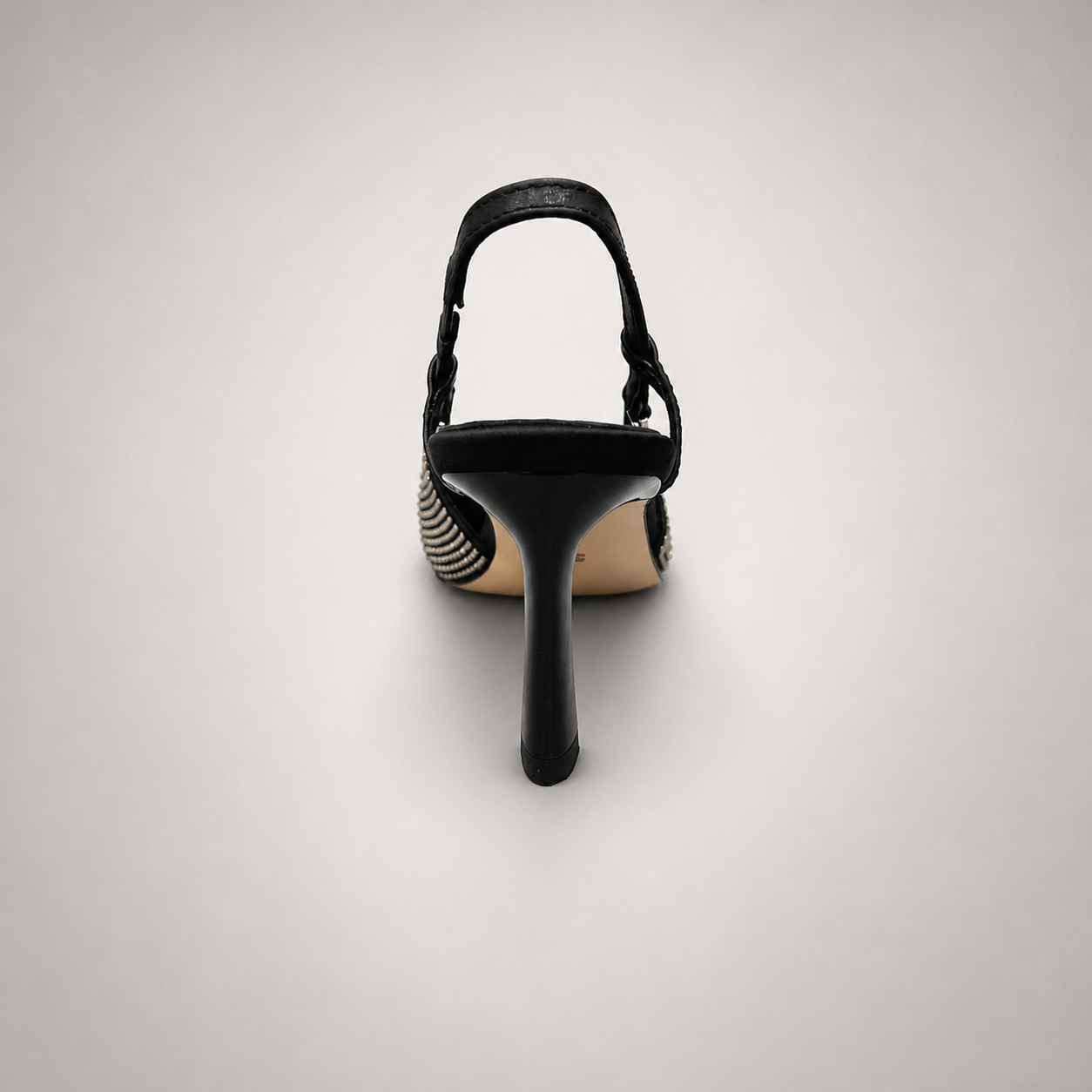 Gray slingback pump rear view showing a pointed toe and double slingback straps