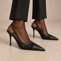 Black lace-panel pointed-toe slingback pumps worn with black trousers