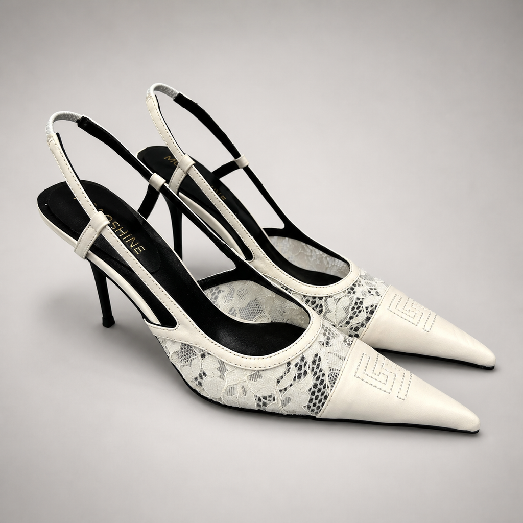 White slingback pump pair three-quarter view showing a pointed toe and lace-panel upper