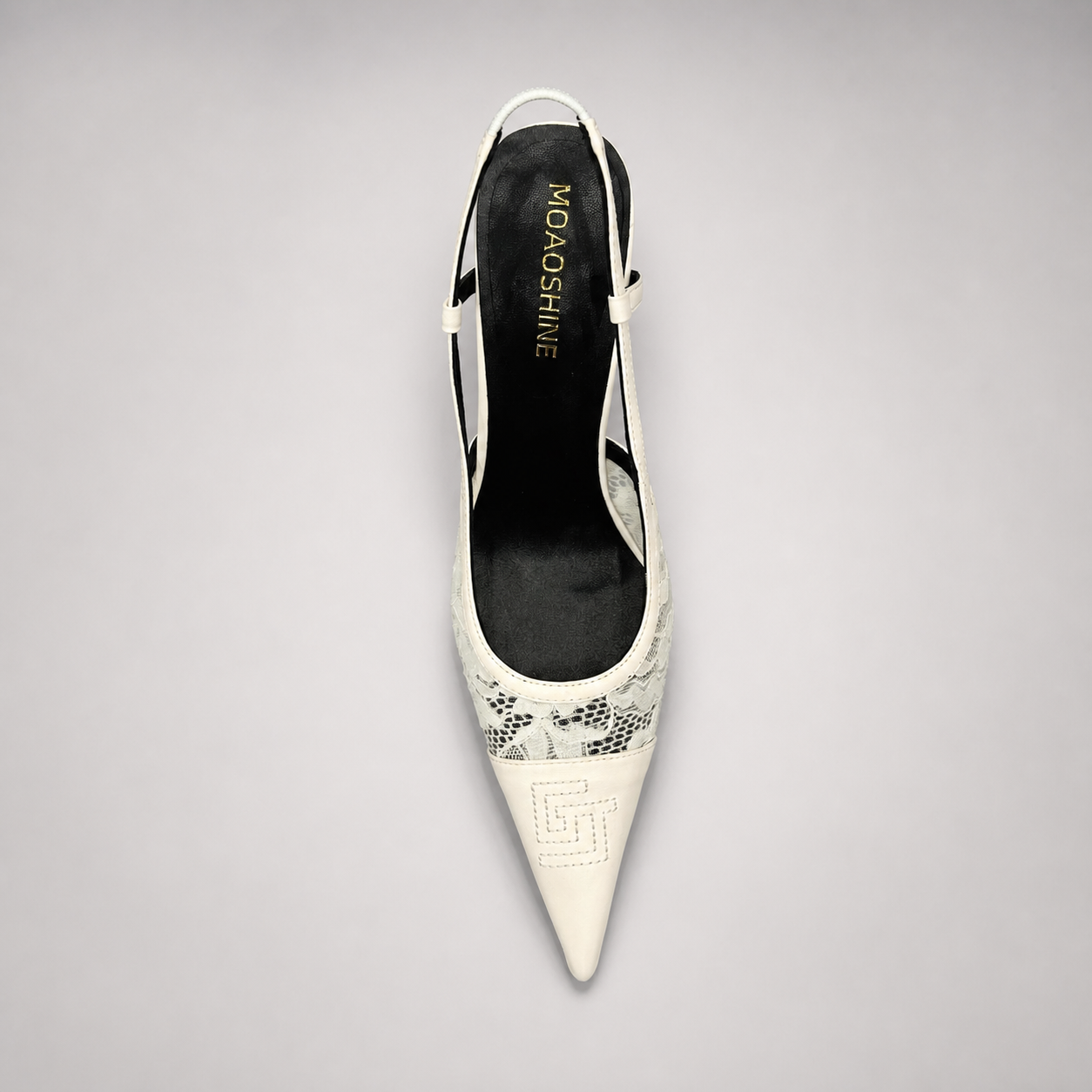 White slingback pump rear view showing a pointed toe and lace-panel upper