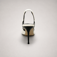 White slingback pump top view showing a pointed toe and lace-panel upper
