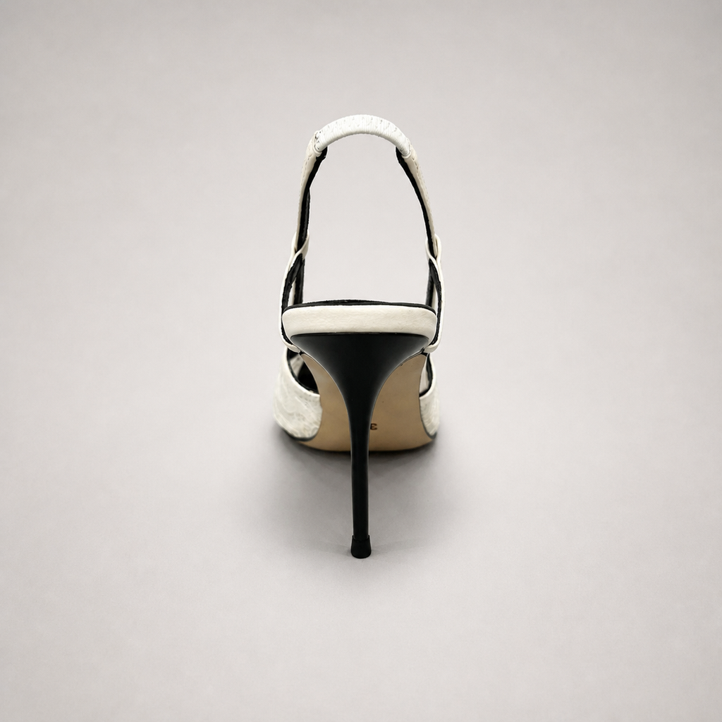 White slingback pump top view showing a pointed toe and lace-panel upper
