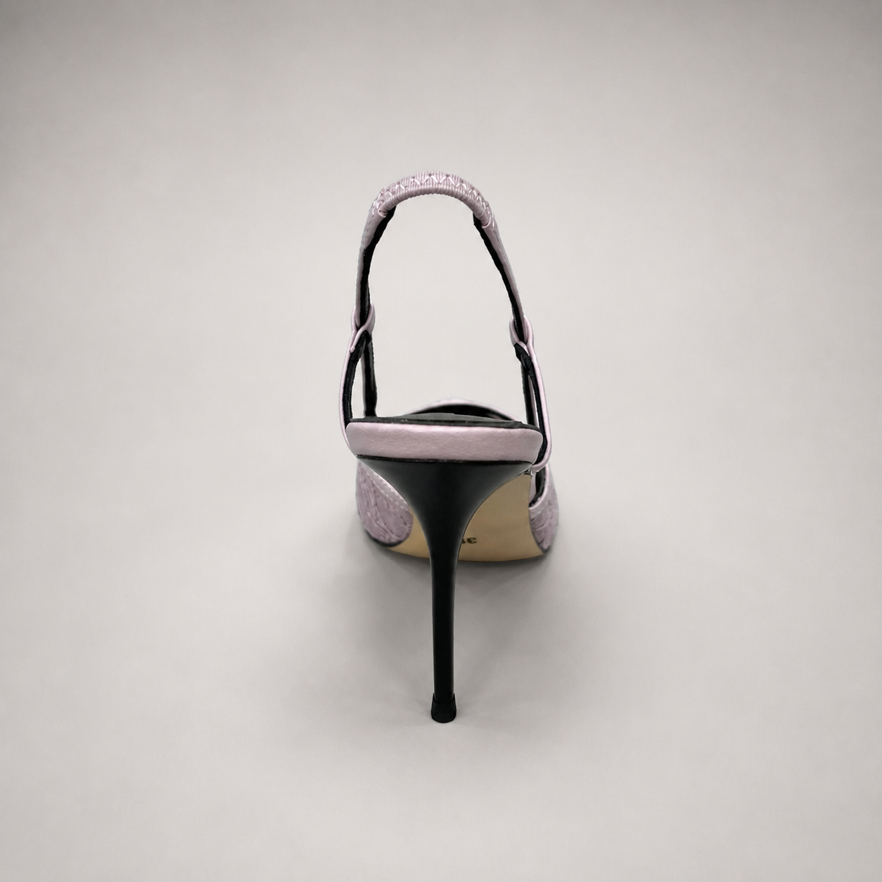 Pink slingback pump top view showing a pointed toe and lace-panel upper